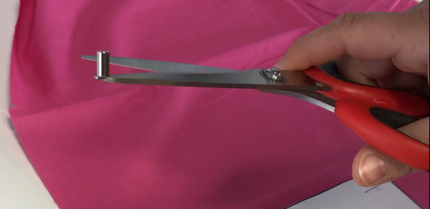 Magnetic attraction of the magnet to the scissors