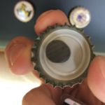 Attached magnet in bottle cap