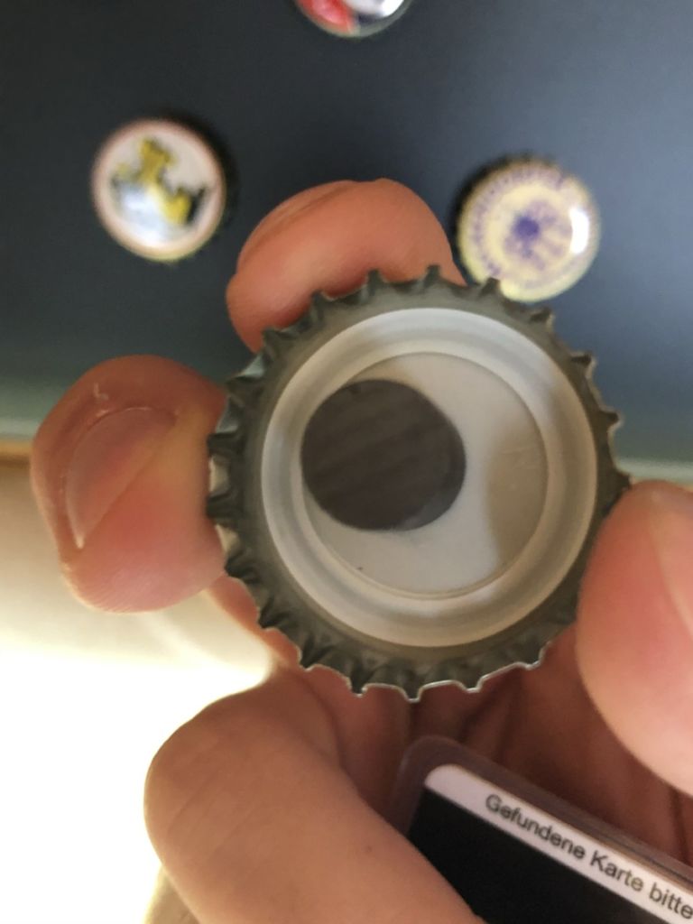 Attached magnet in bottle cap